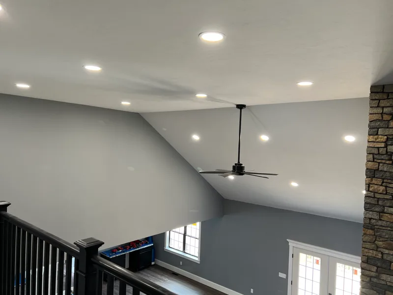Ceiling fan and recessed lighting installation in a vaulted living room